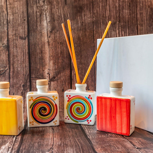 Handcrafted Italian ceramic reed diffusers arranged on rustic wood