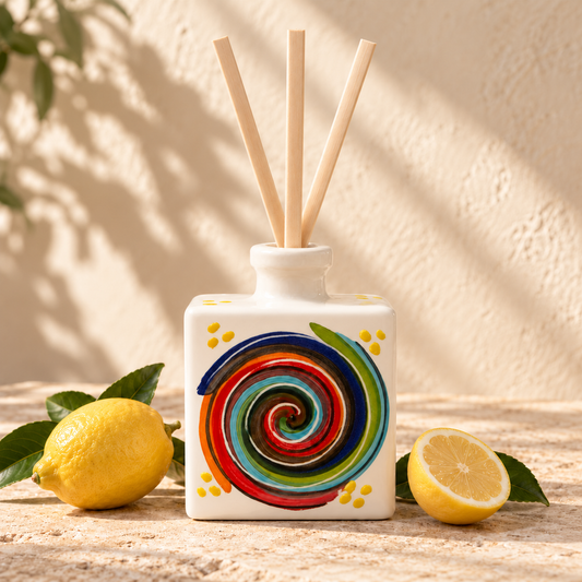 Sorrento ceramic diffuser with yellow dots around a multicoloured spiral on white ceramic